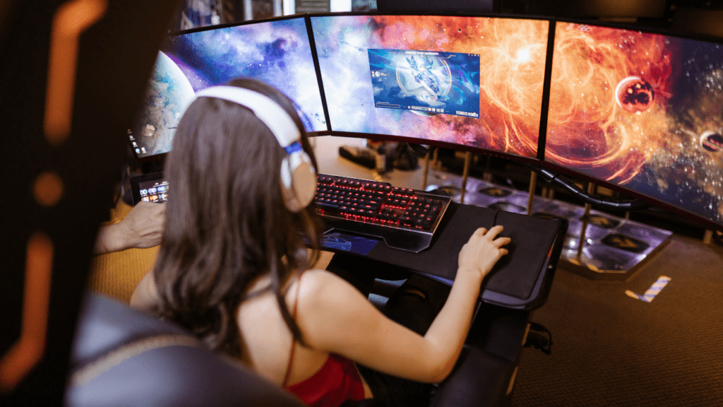 woman playing games in a multi monitor setup